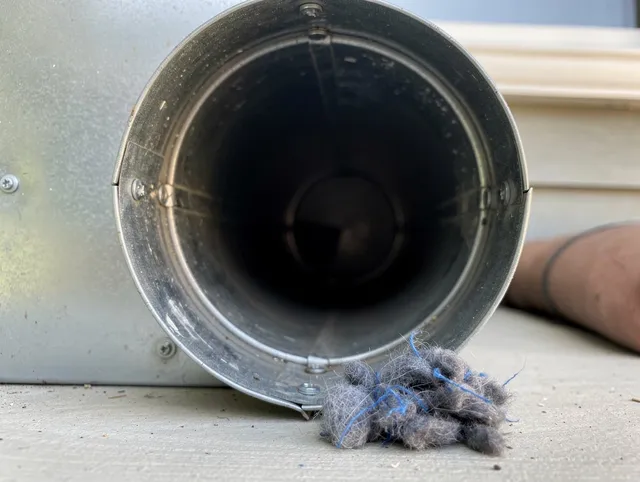 Sanford Dryer Vent Cleaning technician using specialized equipment to clear severe dryer vent blockage in Sanford